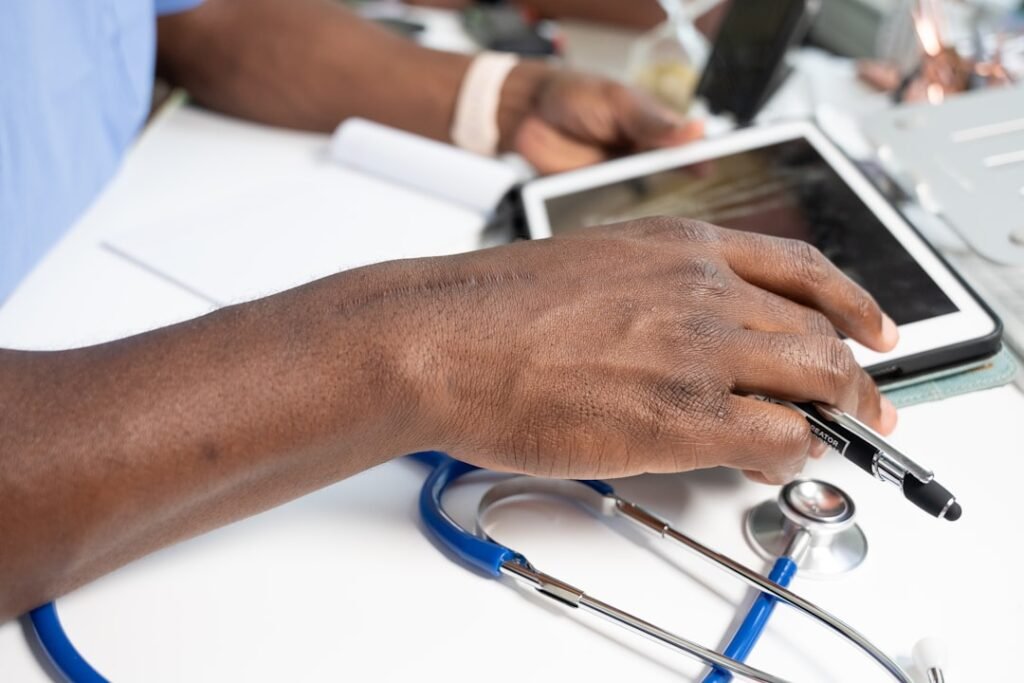Healthcare professional using a laptop in a clinical setting