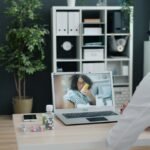 Doctor giving medical advice via video call on laptop