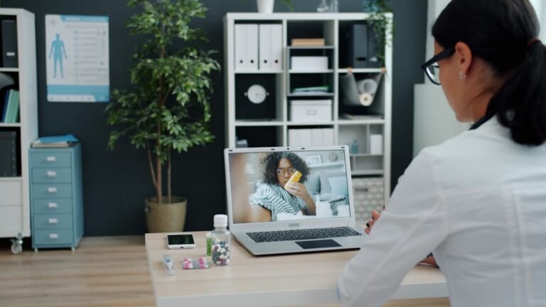Doctor giving medical advice via video call on laptop