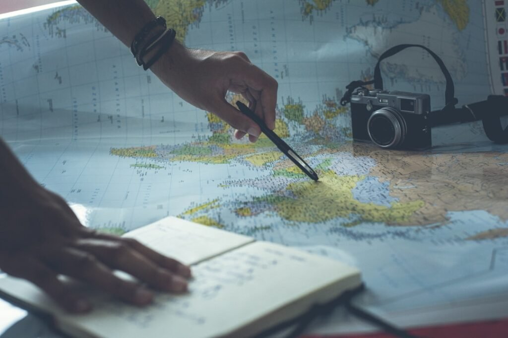Traveler planning a trip with map and notes