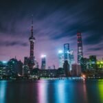 City skyline at night representing the global technology race