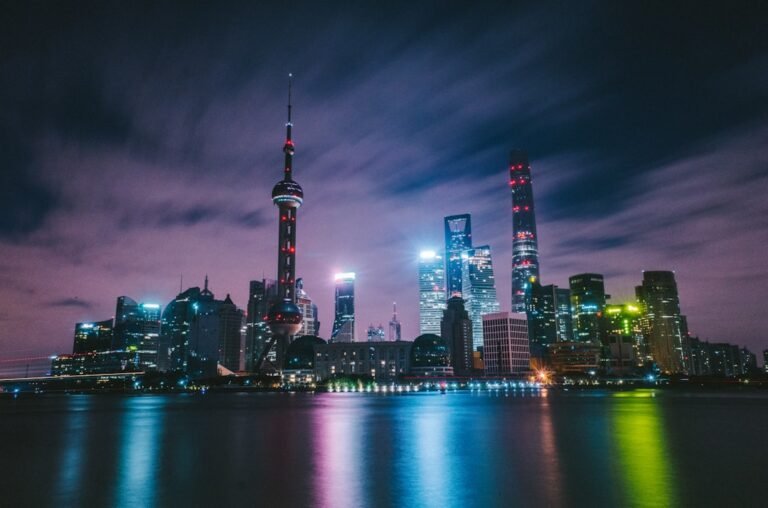City skyline at night representing the global technology race