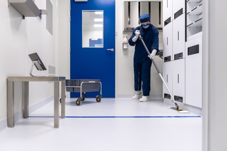 Technician working inside a semiconductor cleanroom